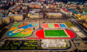 Stadiona izbūves un teritorijas labiekārtošanas darbi Rīgas centra humanitārās vidusskolas lietojumā esošajā teritorijā, «Centra sporta kvartāls» Krišjāņa Barona ielā 116A, Rīga. Pasūtītājs Rīgas Domes Īpašuma departaments. Projekts Anna Vasiljeva, Rūdolfs Šķēle, RDĪD. Būvnieks PS «LNK Industries Partnership», projekta vadītājs Jevgenijs Volkovs. Būvuzraudzība «CMB», Māris Briška.